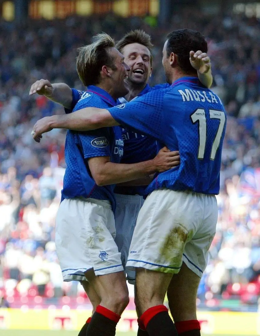 Kevin Muscat (right) celebrates with team-mates while playing for Rangers