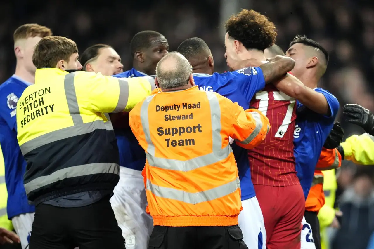 Curtis Jones (centre) and Everton’s Abdoulaye Doucoure are separated