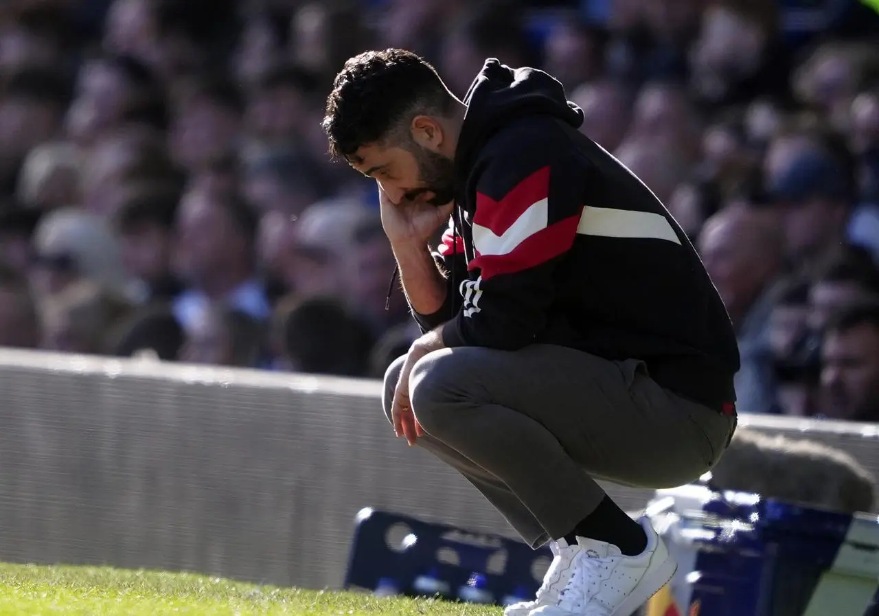 Ruben Amorim crouches down