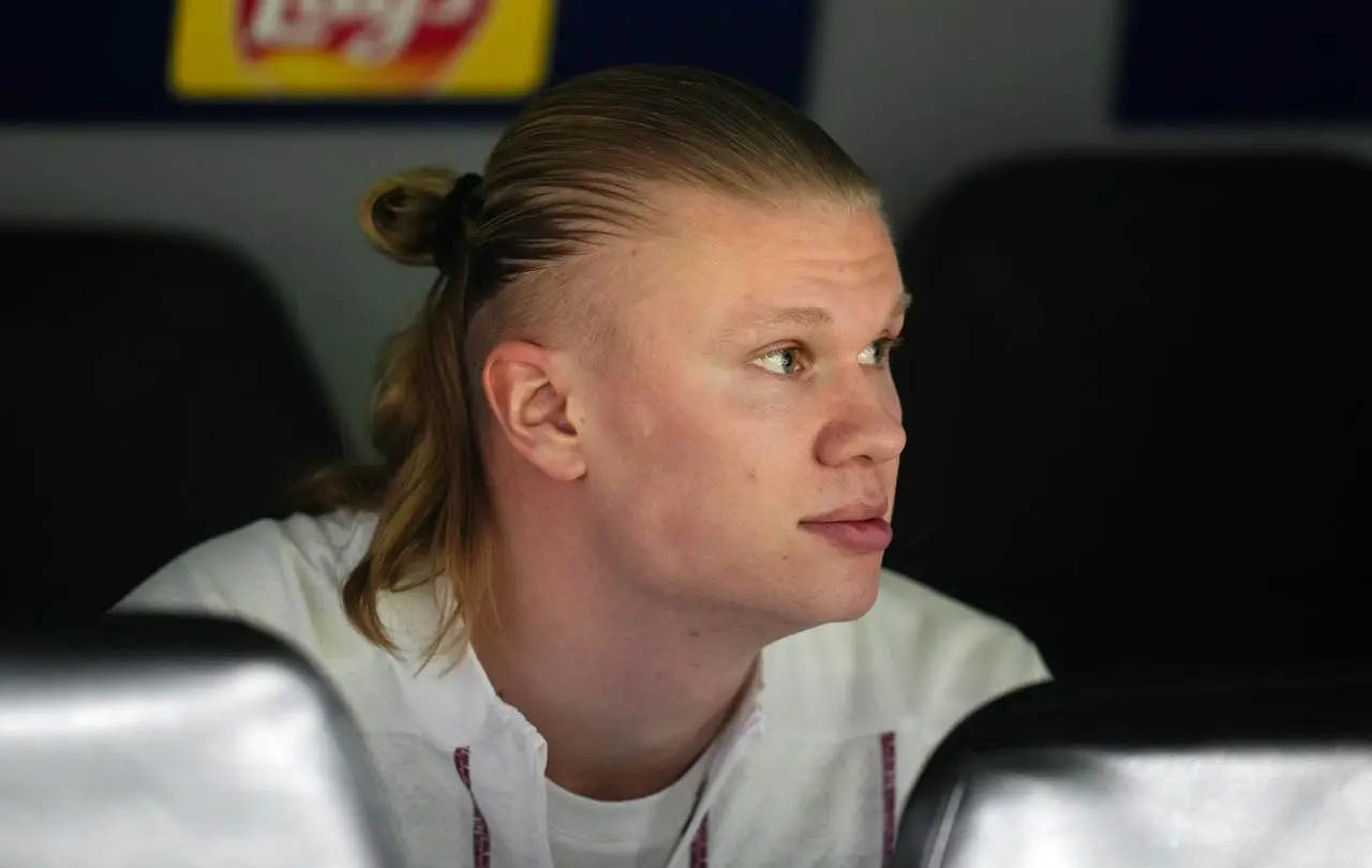 Erling Haaland sits on the Real Madrid bench in the game at Real Madrid