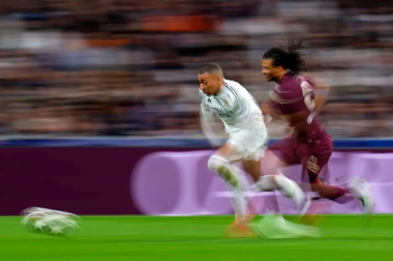 Manchester City’s Nathan Ake, right, chases as Real Madrid’s Kylian Mbappe runs with the ball