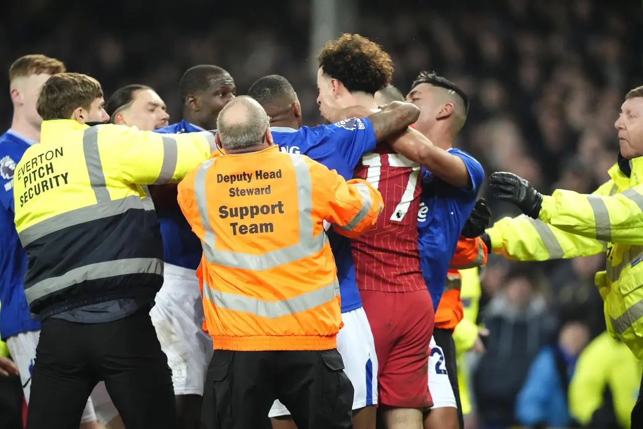 Liverpool’s Curtis Jones (centre) and Everton’s Abdoulaye Doucoure are separated by team-mates and members of the ground staff following a clash after the final whistle in the Premier League match at Goodison Park