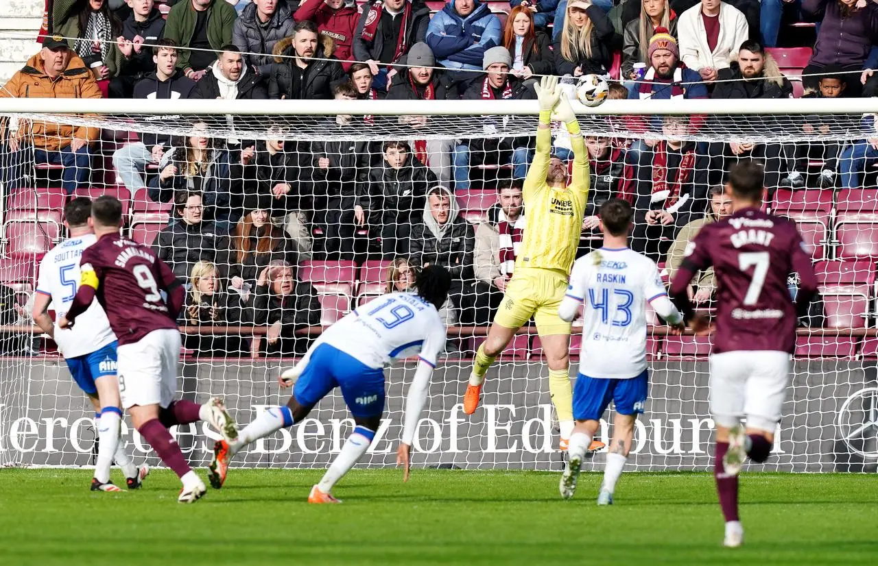 Rangers goalkeeper Jack Butland, centre, saves Lawrence Shankland's long-range volley