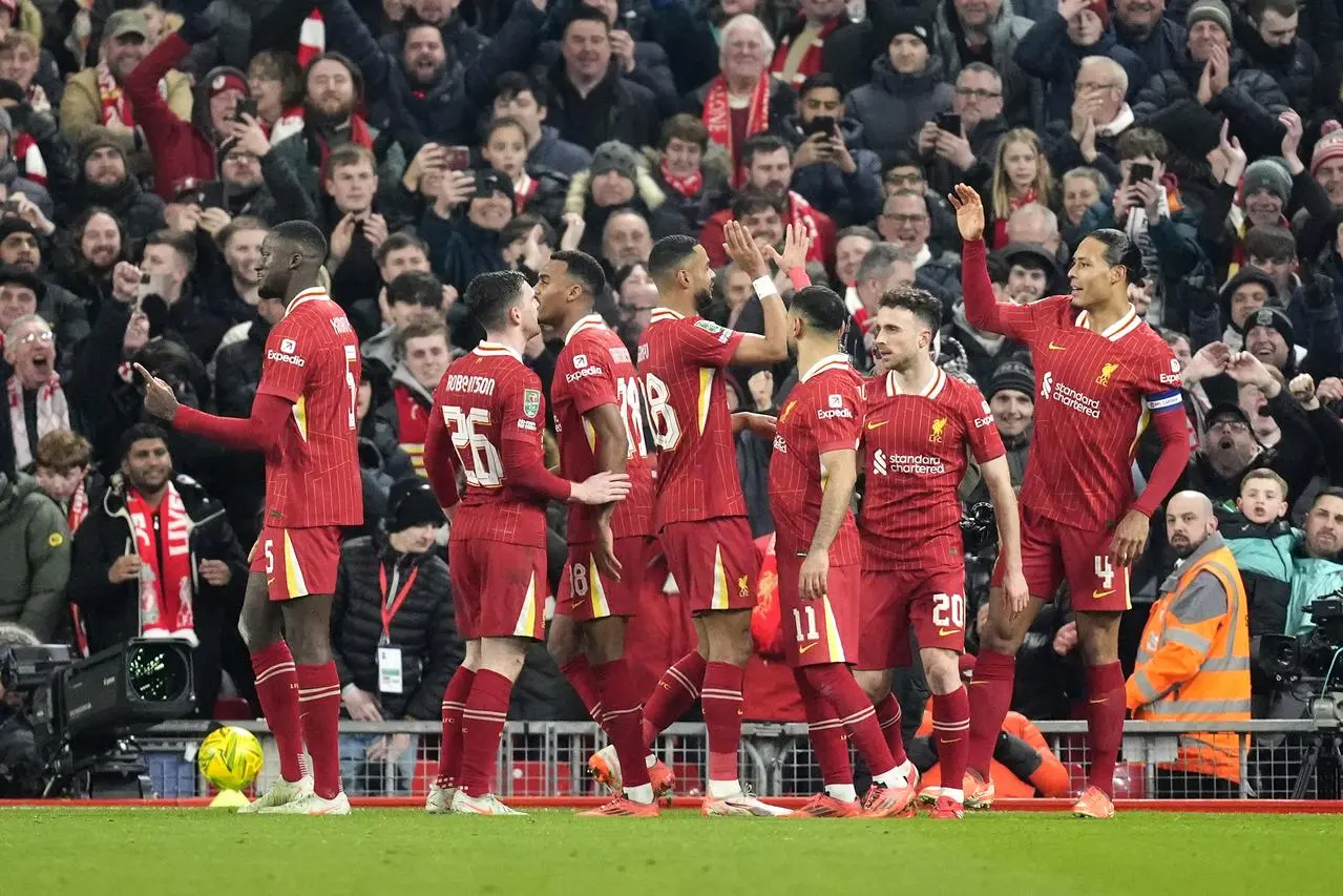 Liverpool players celebrate after scoring their fourth goal