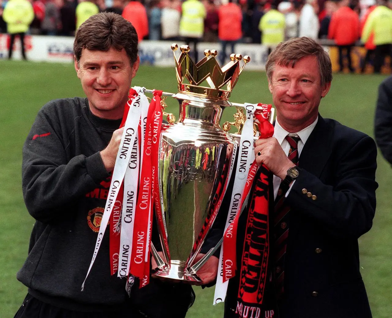 Manchester United manager Alex Ferguson (right) and assistant manager Brian Kidd holding aloft the Premiership trophy after beating Middlesbrough at the Riverside Stadium