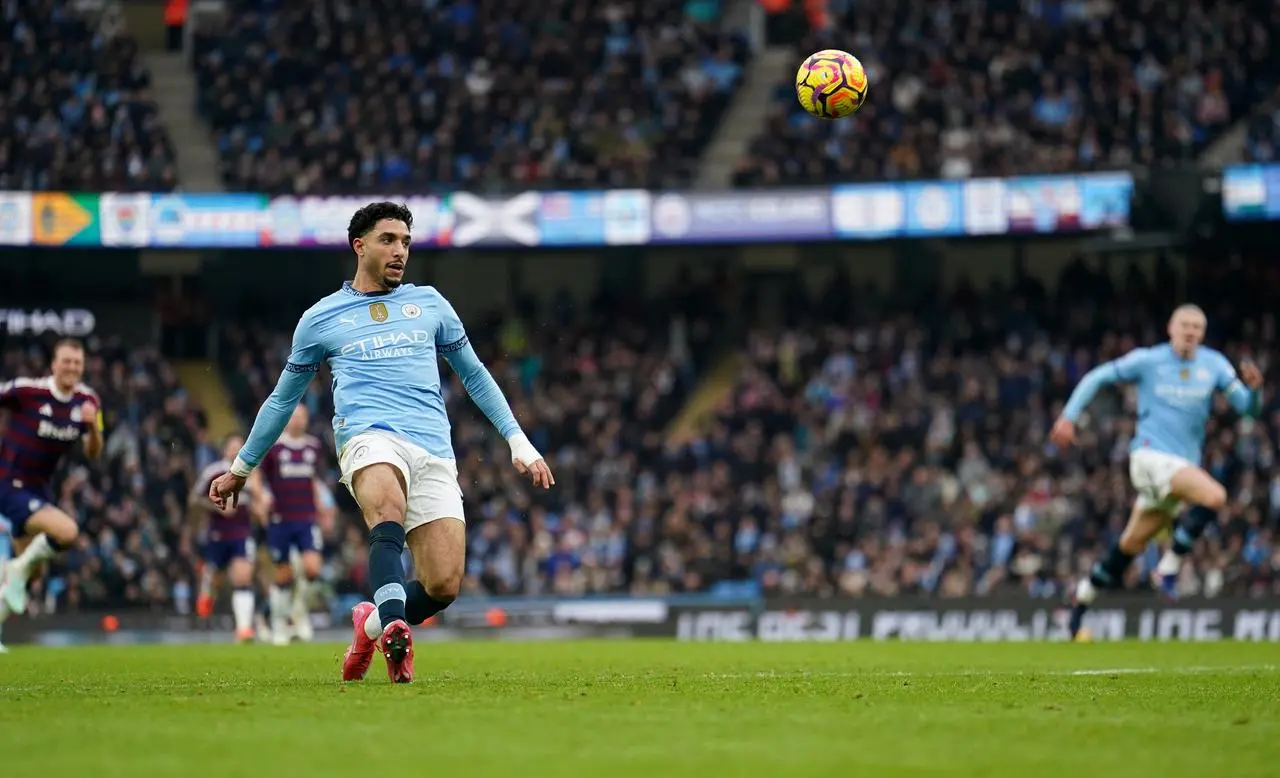 Manchester City’s Omar Marmoush scores the first of his three goals against Newcastle by lobbing goalkeeper Martin Dubravka