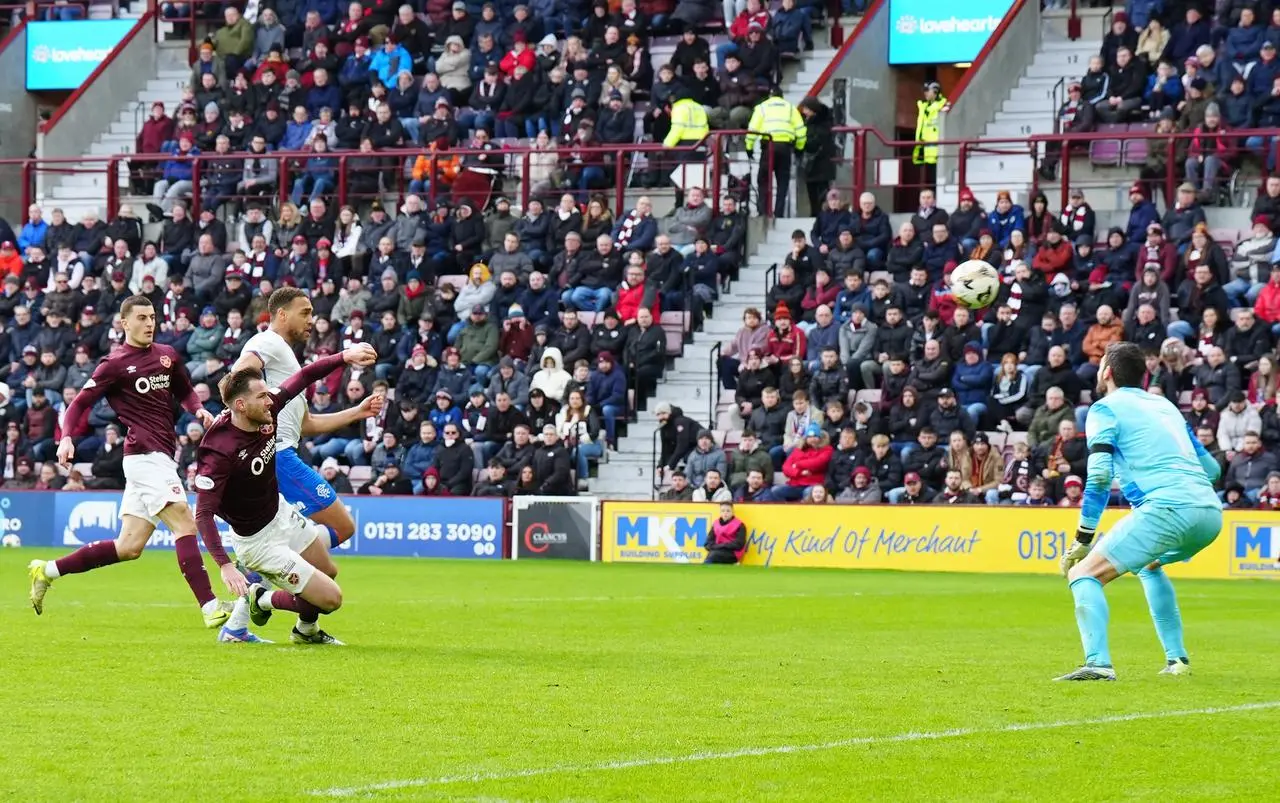 Hearts' Jamie McCart, second left, scores his second own goal under pressure from Rangers' Cyriel Dessers