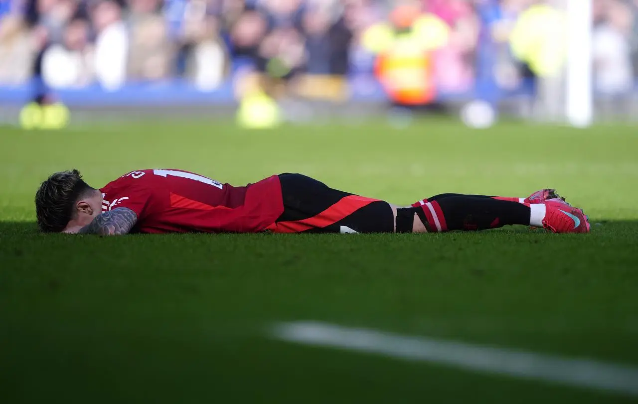 Alejandro Garnacho lies on the pitch following the draw with Everton 