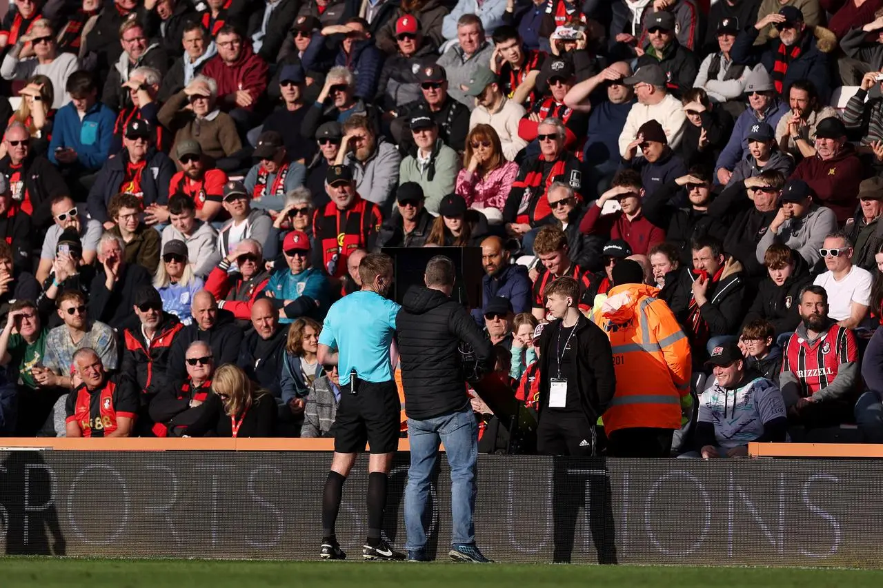 Referee Michael Salisbury is sent to the VAR monitor to check for a possible red card for Bournemouth’s Illya Zabarnyi