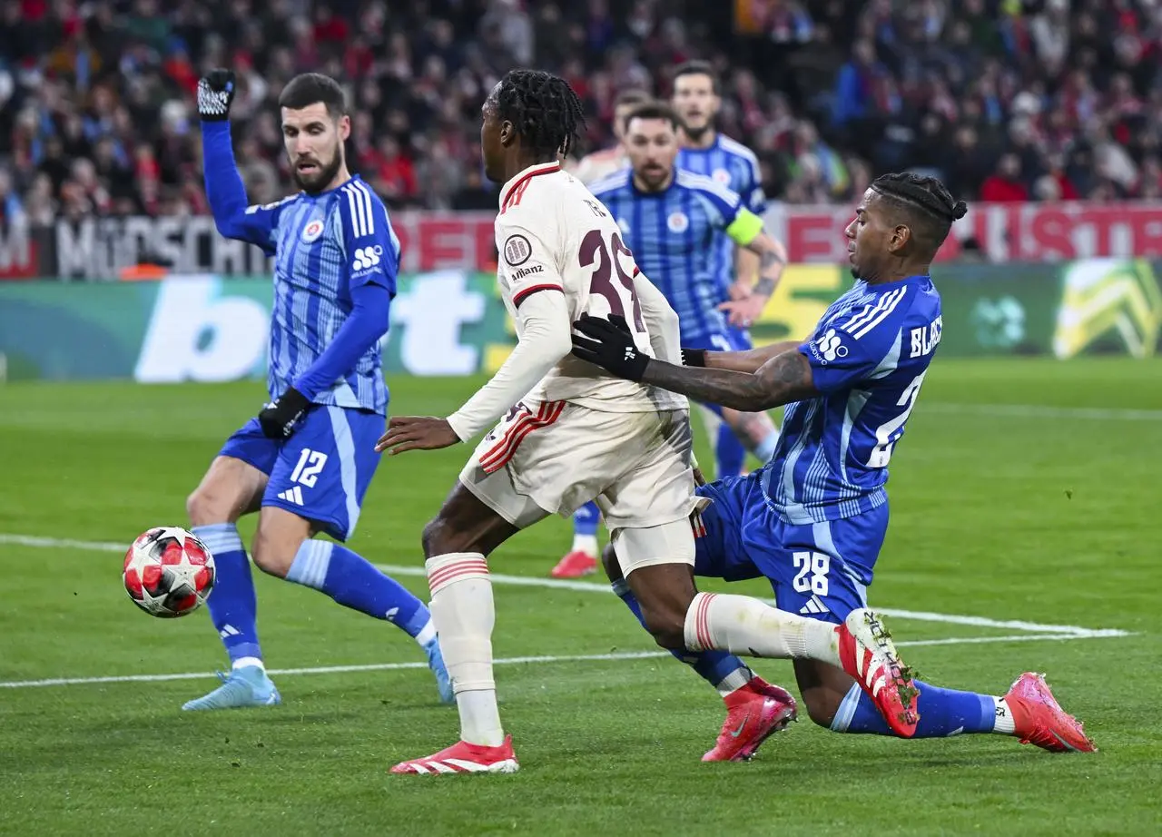 Bayern Munich's Mathys Tel, centre, takes on the Slovan Bratislava defence