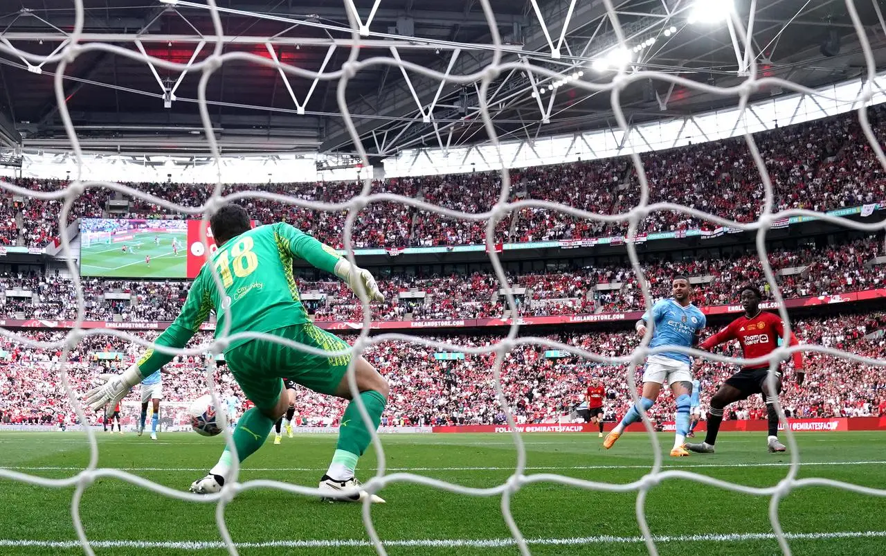 Kobbie Mainoo scores Manchester United’s second goal past Manchester City keeper Stefan Ortega Moreno in last season's FA Cup final