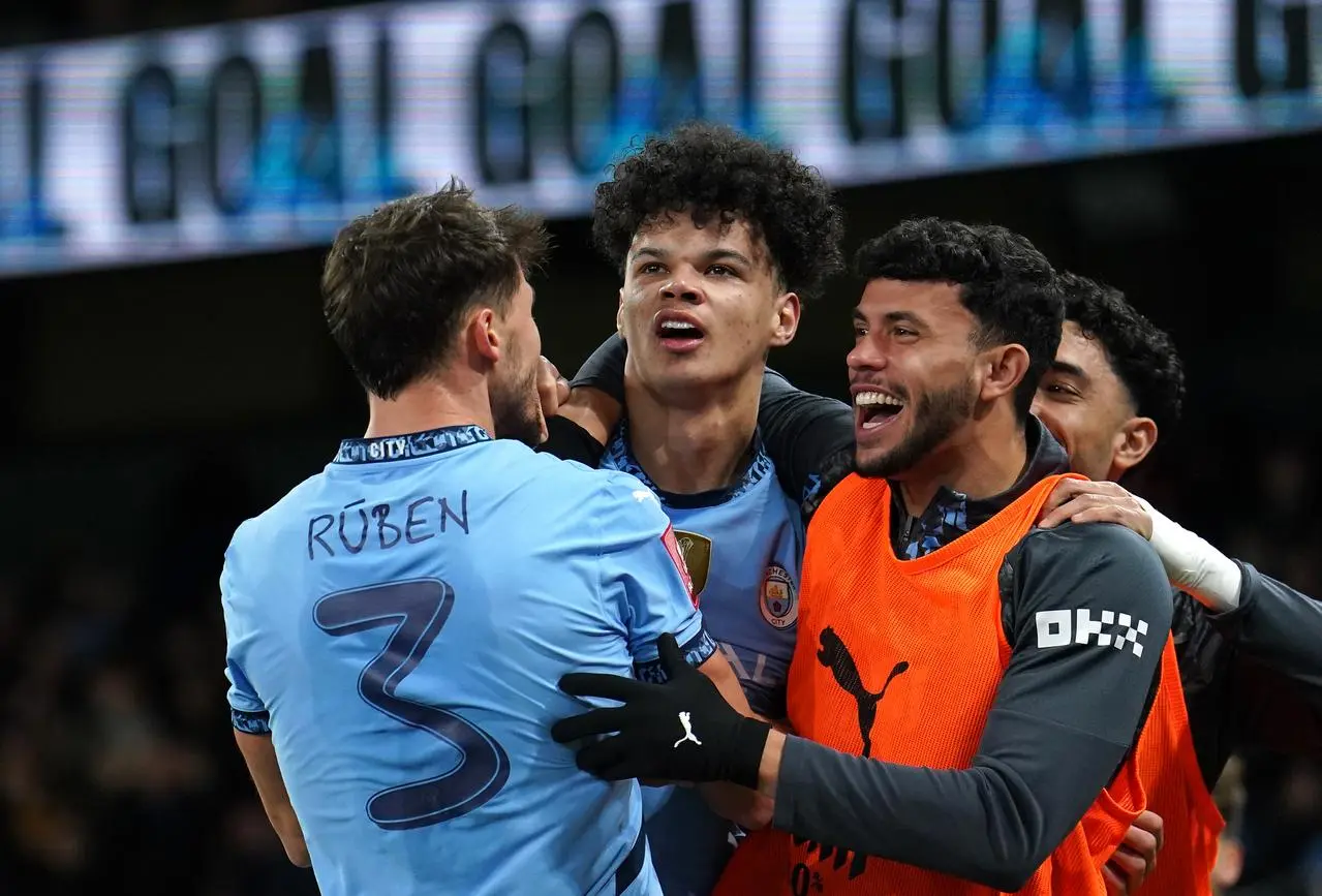 Nico O’Reilly, centre, celebrates scoring Manchester City’s second goal against Plymouth