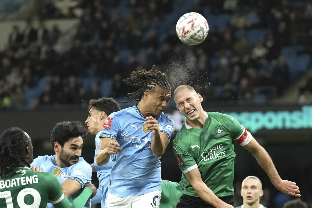 Nathan Ake challenges for the ball with Plymouth defender Nikola Katic