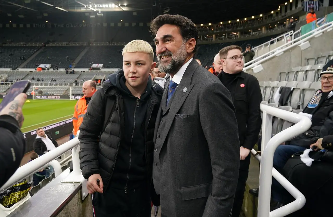 Newcastle United chairman Yasir Al-Rumayyan poses for a photograph with a fan before the Premier League match at St. James’ Park, Newcastle.