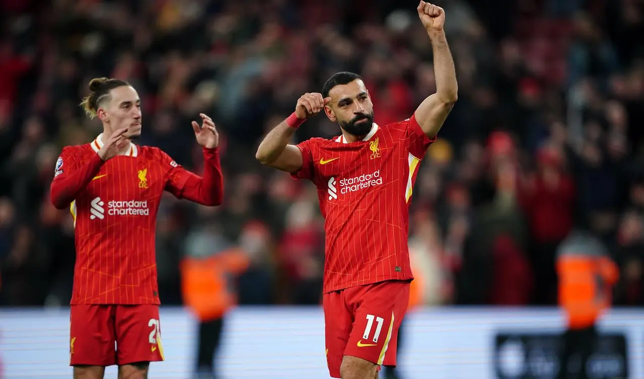 Liverpool’s Mohamed Salah and Kostas Tsimikas salute the fans after a game