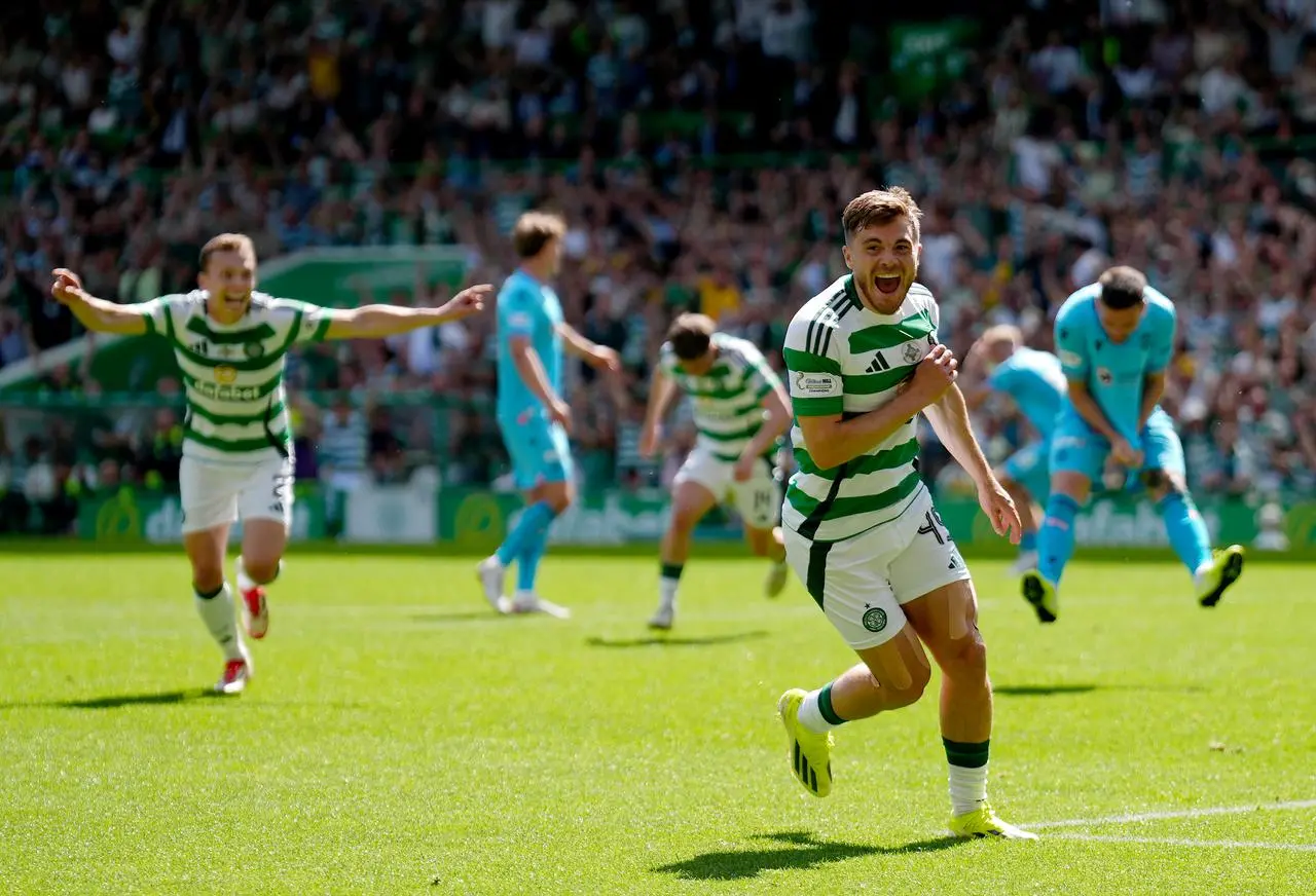 James Forrest celebrates as St Mirren players look dejected behind him