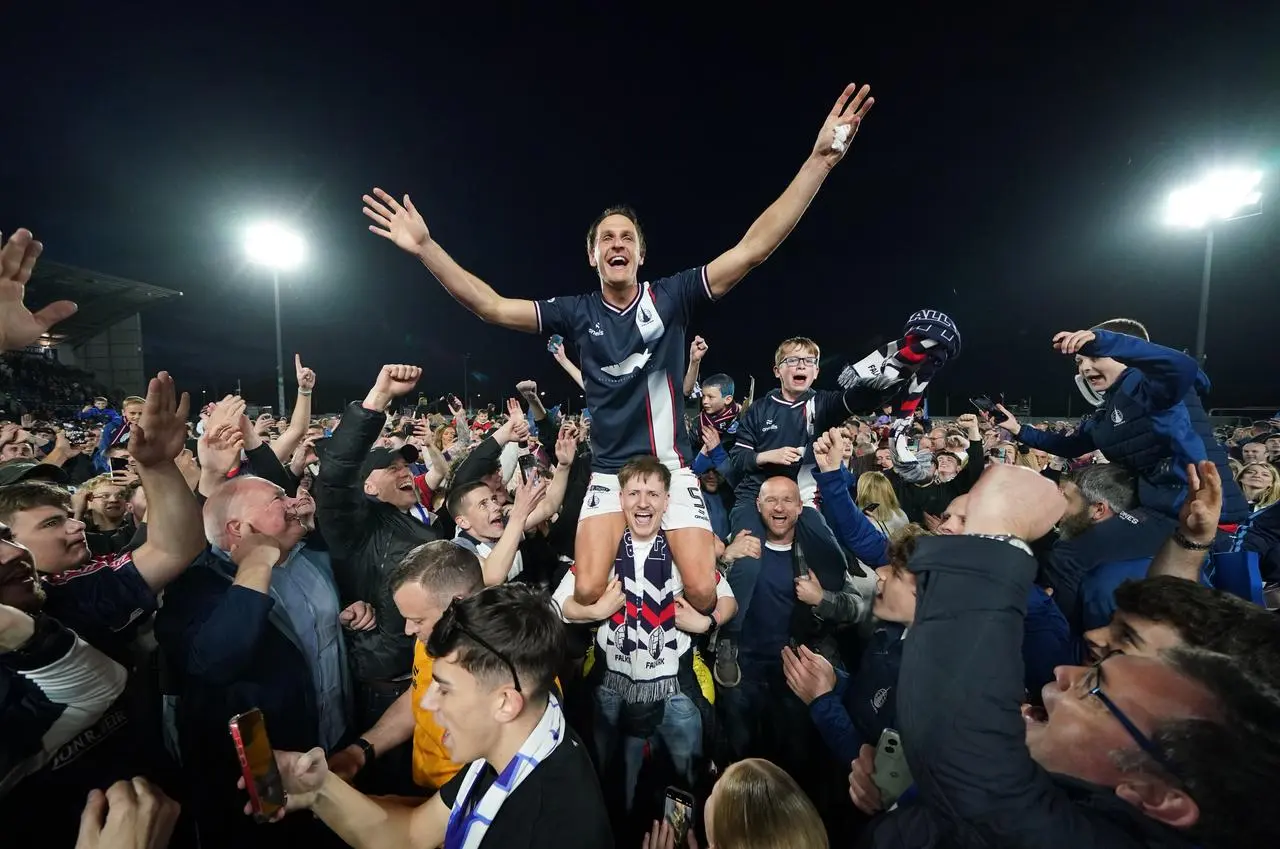 Liam Henderson celebrates winning the league on top of the shoulders of fans 