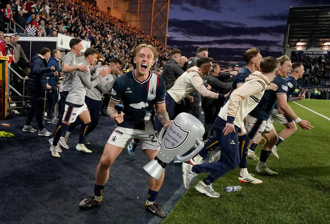 Calvin Miller roars with delight as colleagues run on to the pitch at the final whistle
