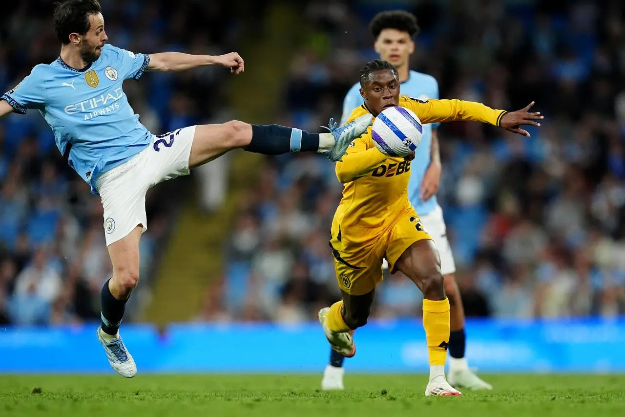 Jean-Ricner Bellegarde (right) is tackled by Manchester City’s Bernardo Silva 