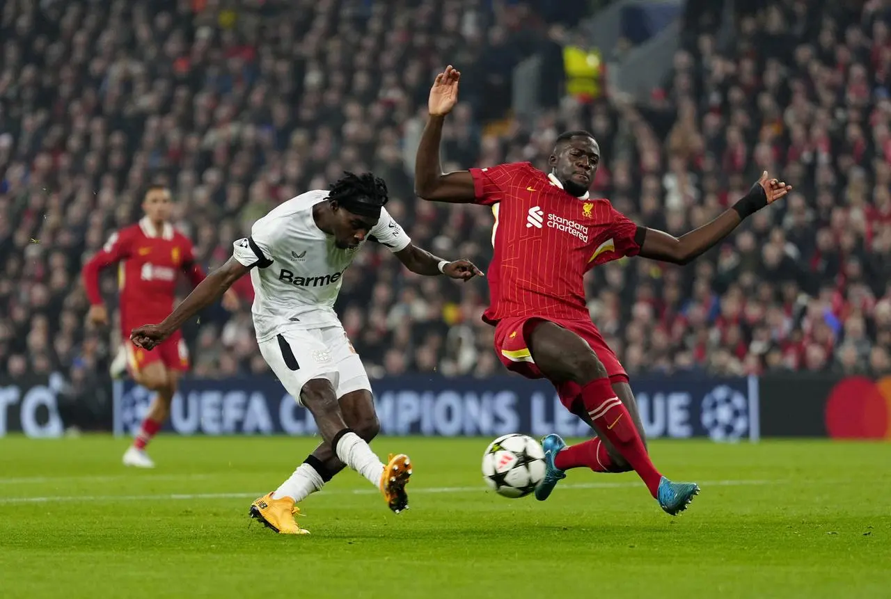 Bayer Leverkusen’s Jeremie Frimpong takes a shot as he is tackled by Liverpool's Ibrahima Konate