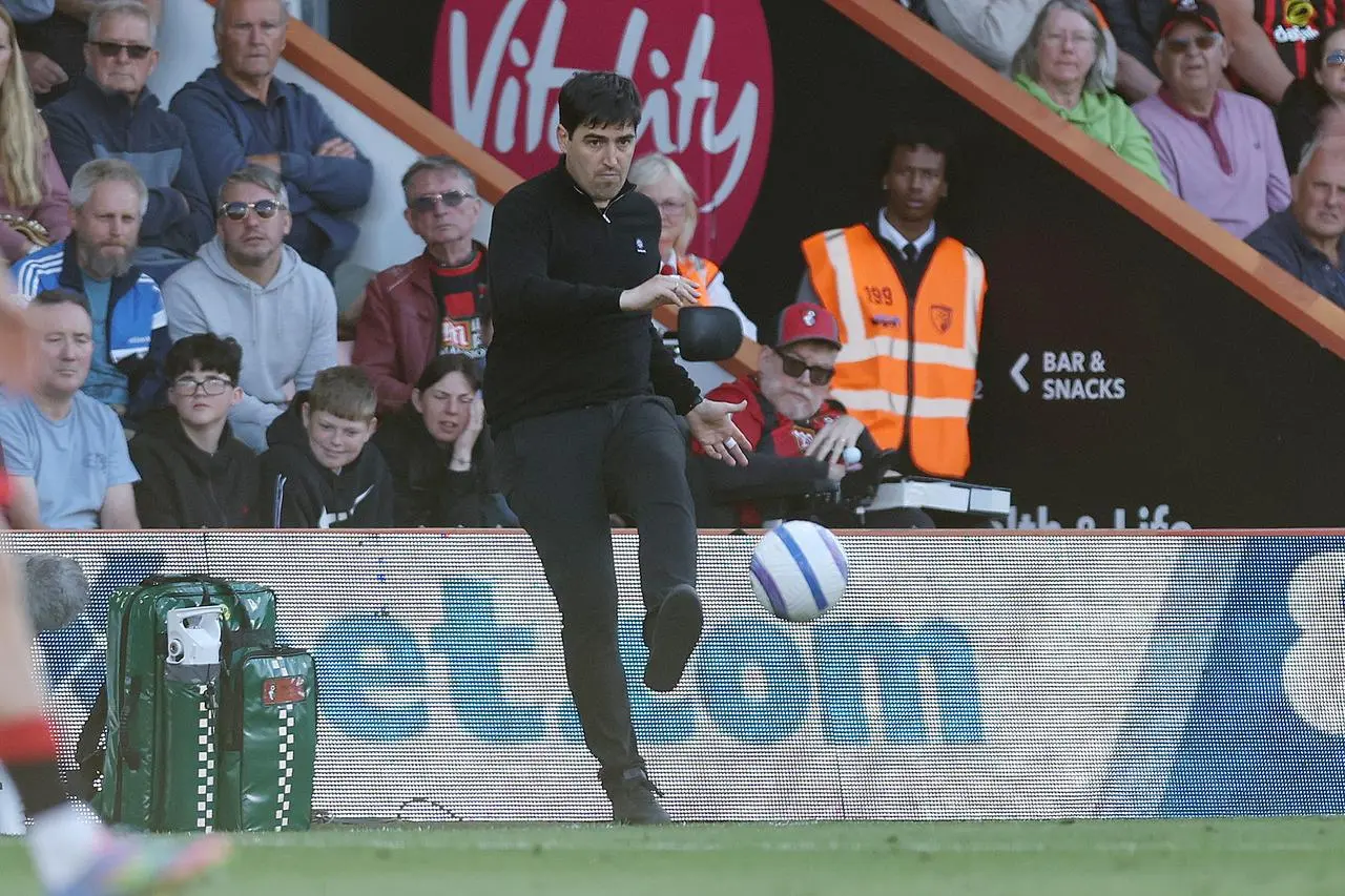 Bournemouth manager Andoni Iraola kicks the ball on the touchline