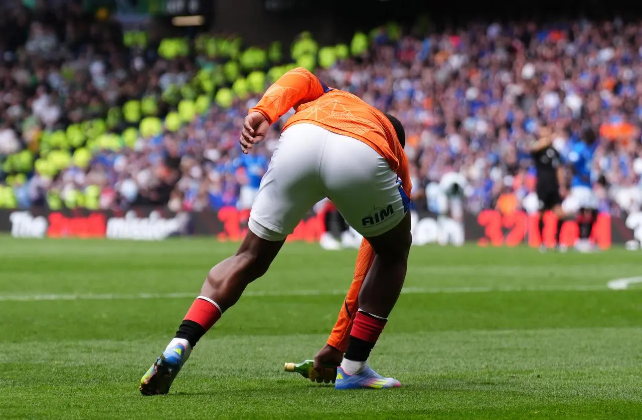 Rangers sub Neraysho Kasanwirjo clears away a glass bottle