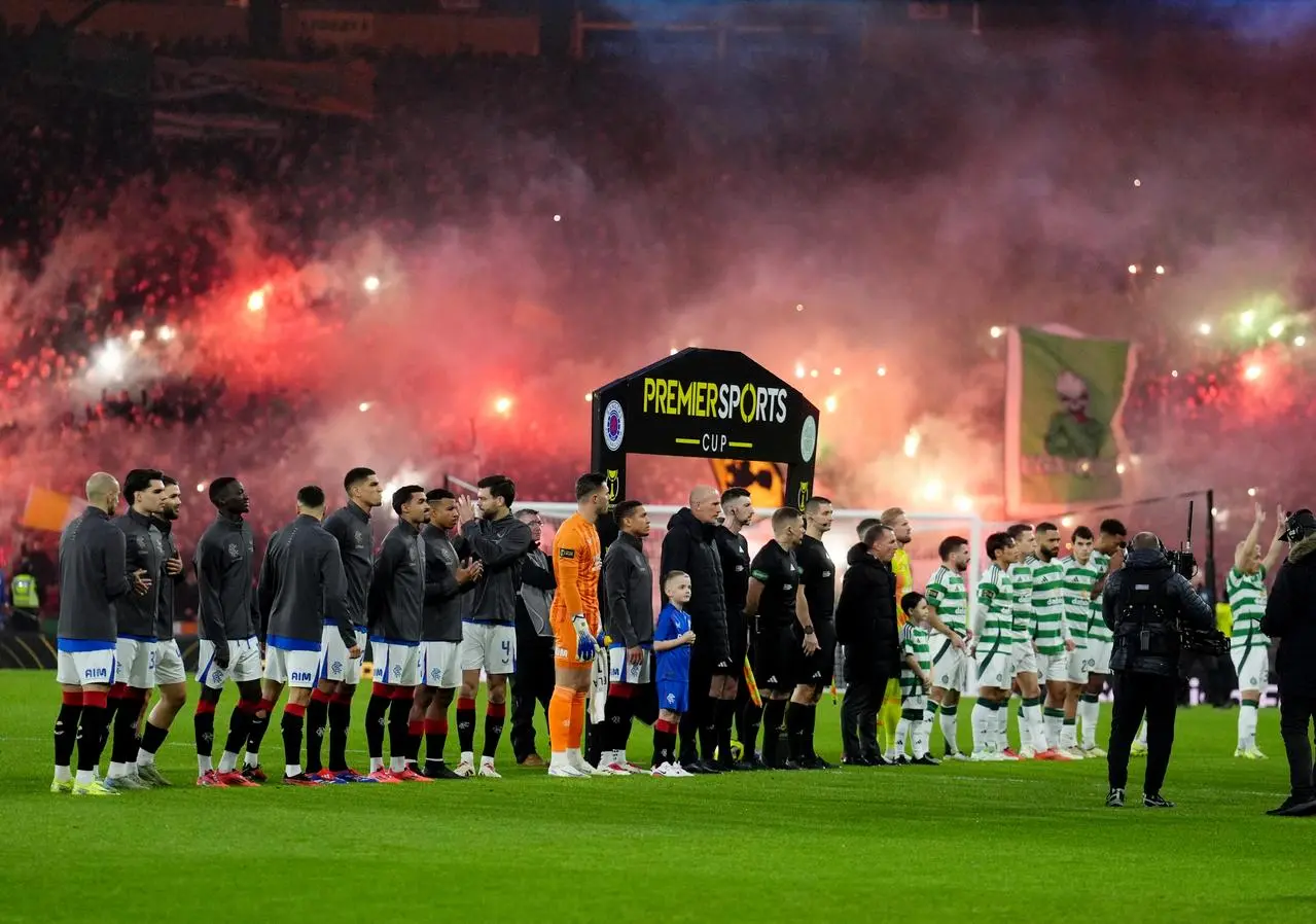 Celtic fans let off flares while their team and Rangers line up ahead of the Premier Sports Cup final