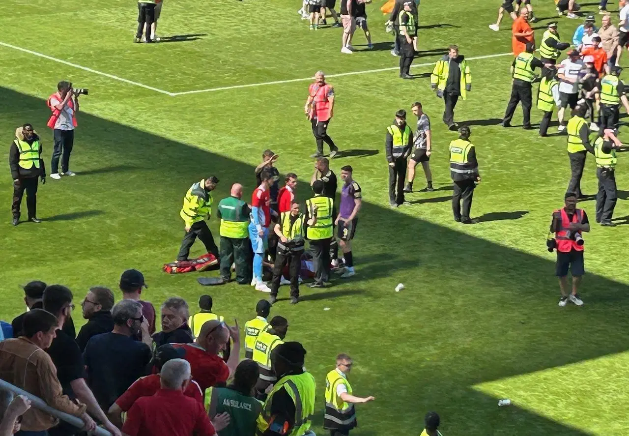 Aberdeen’s Jack MacKenzie gets treatment on the pitch after being struck by a seat
