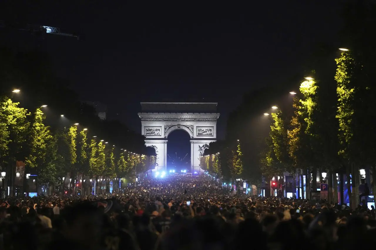 Fans celebrate PSG’s victory on the Champs-Elysees