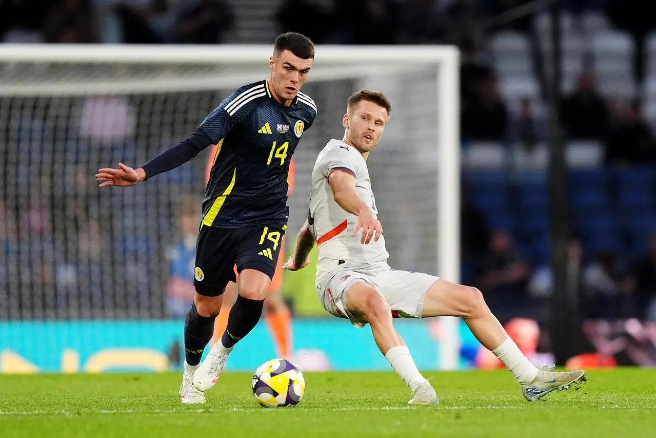 Lennon Miller, left, on the ball for Scotland