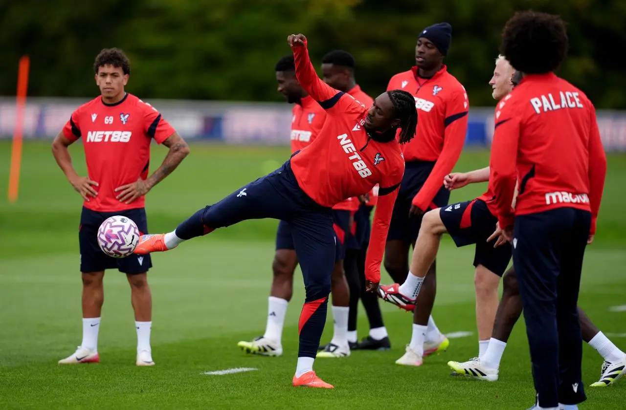 Crystal Palace’s Eberechi Eze volleys a ball in training surrounded by team-mates