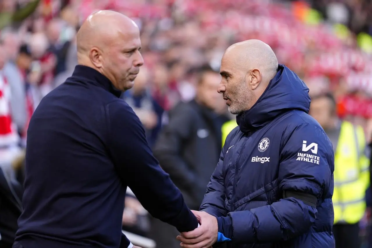 Liverpool head coach Arne Slot, left, and Chelsea boss Enzo Maresca shake hands