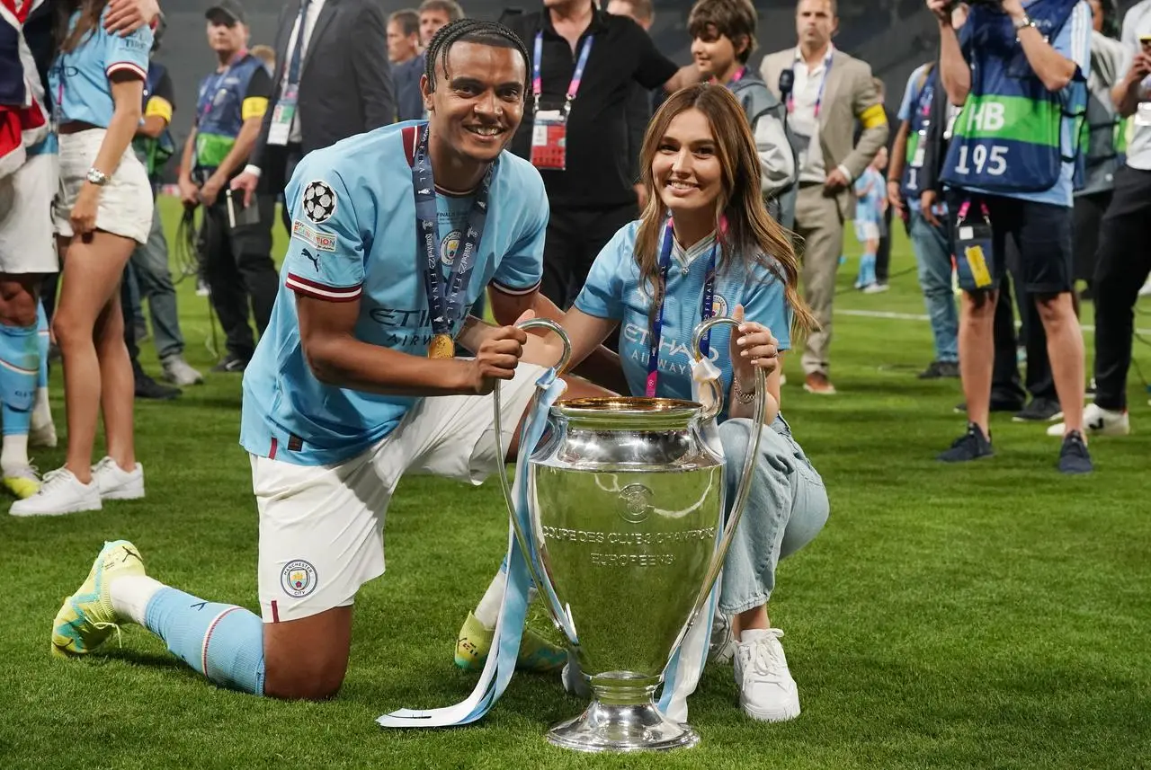 Manchester City’s Manuel Akanji poses with the Champions League trophy with his wife Melanie 