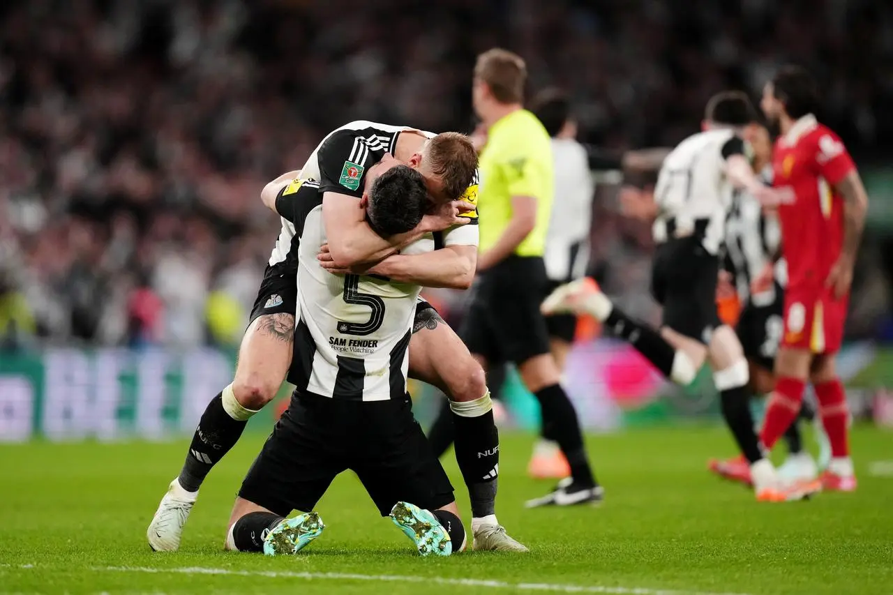 Newcastle’s Dan Burn (centre right) and Fabian Schar celebrate winning the Carabao Cup final against Liverpool at Wembley