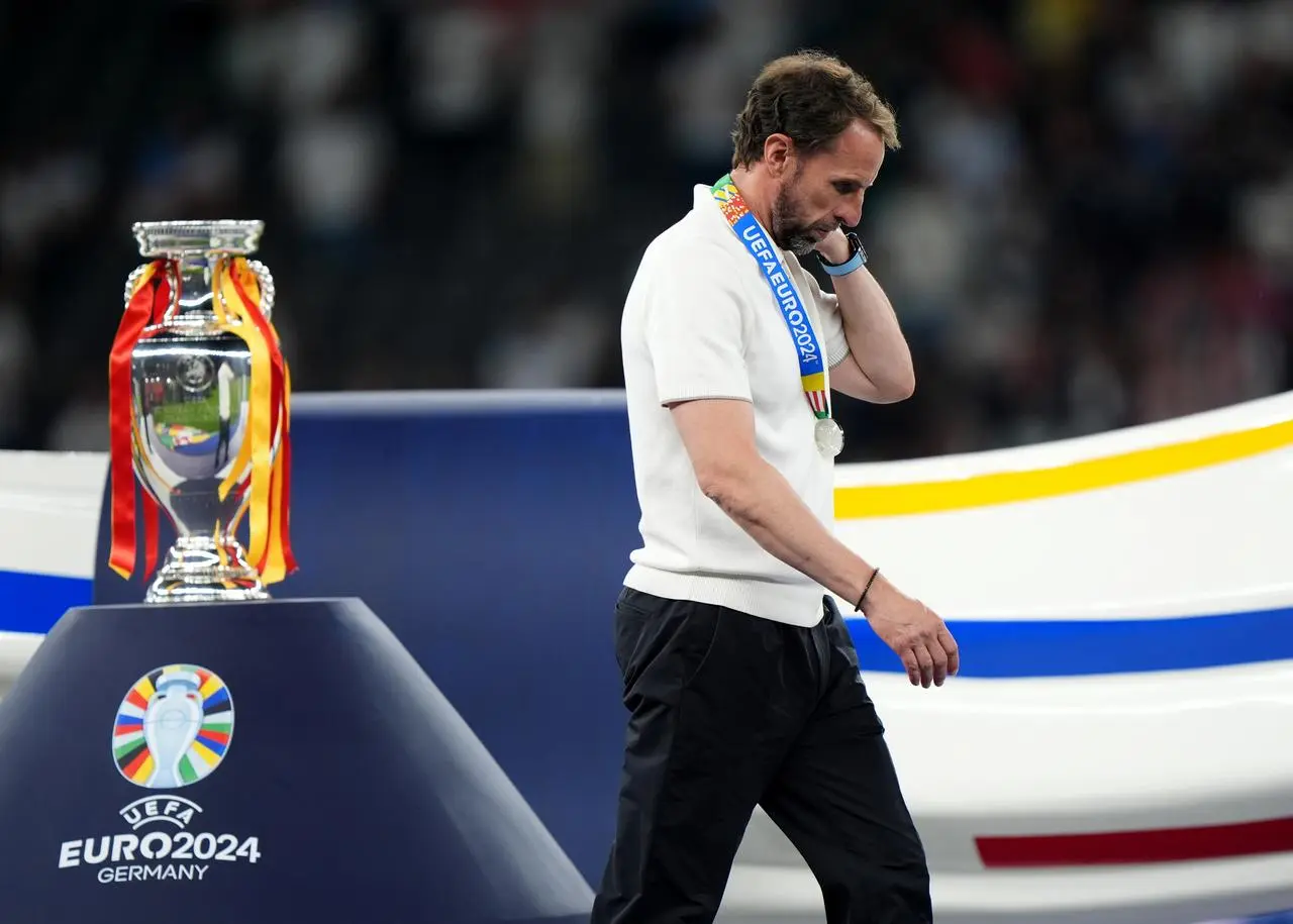 England manager Gareth Southgate walks past the trophy