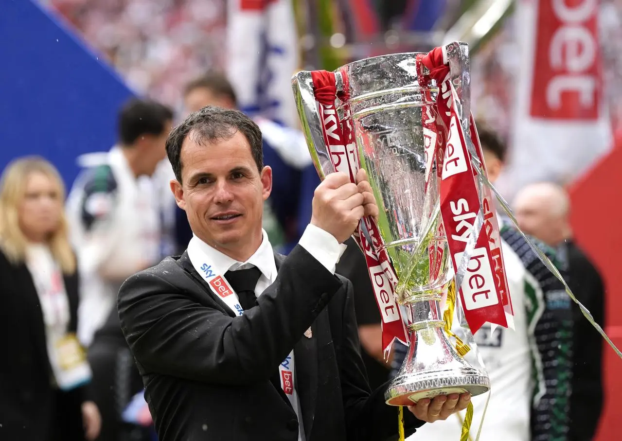 Regis Le Bris holding the trophy