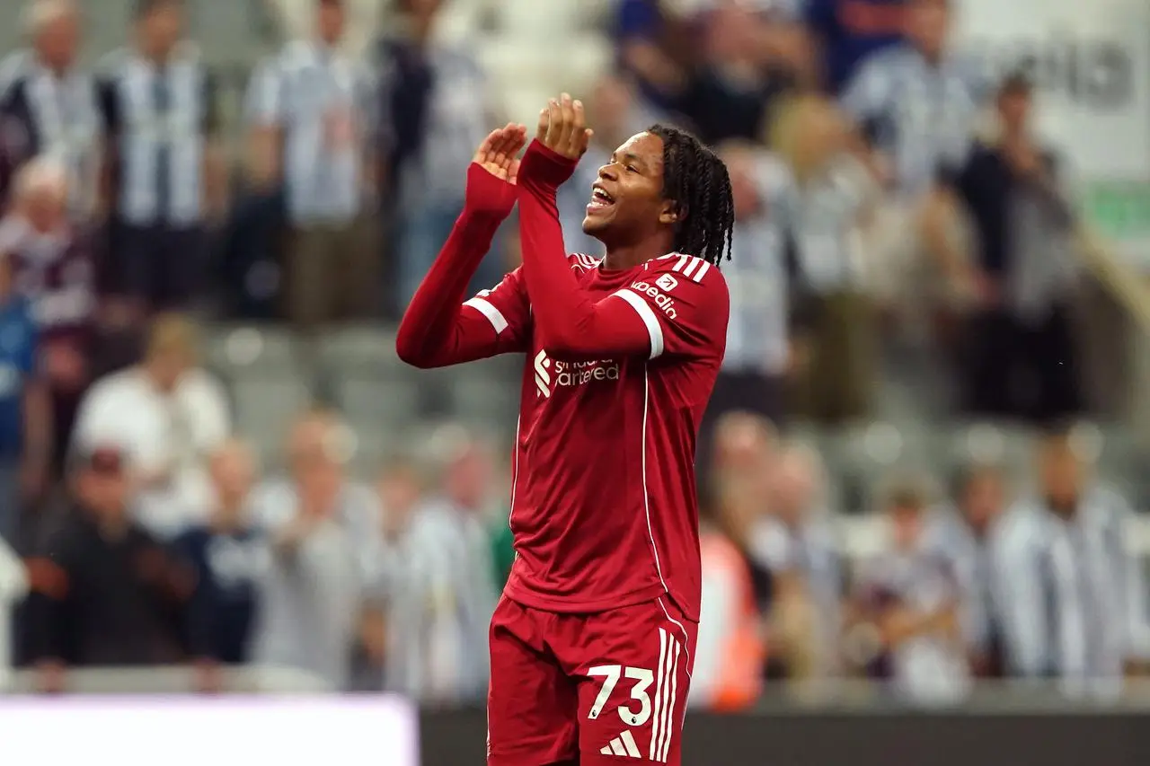 Rio Ngumoha applauds Liverpool fans after the win against Newcastle