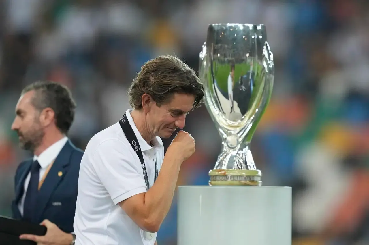Tottenham boss Thomas Frank passes the trophy during the medal ceremony