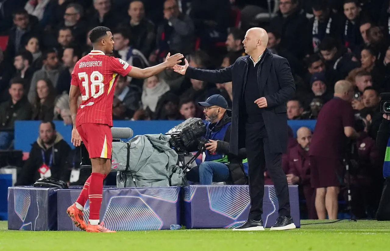 Liverpool head coach Arne Slot congratulates midfielder Ryan Gravenberch
