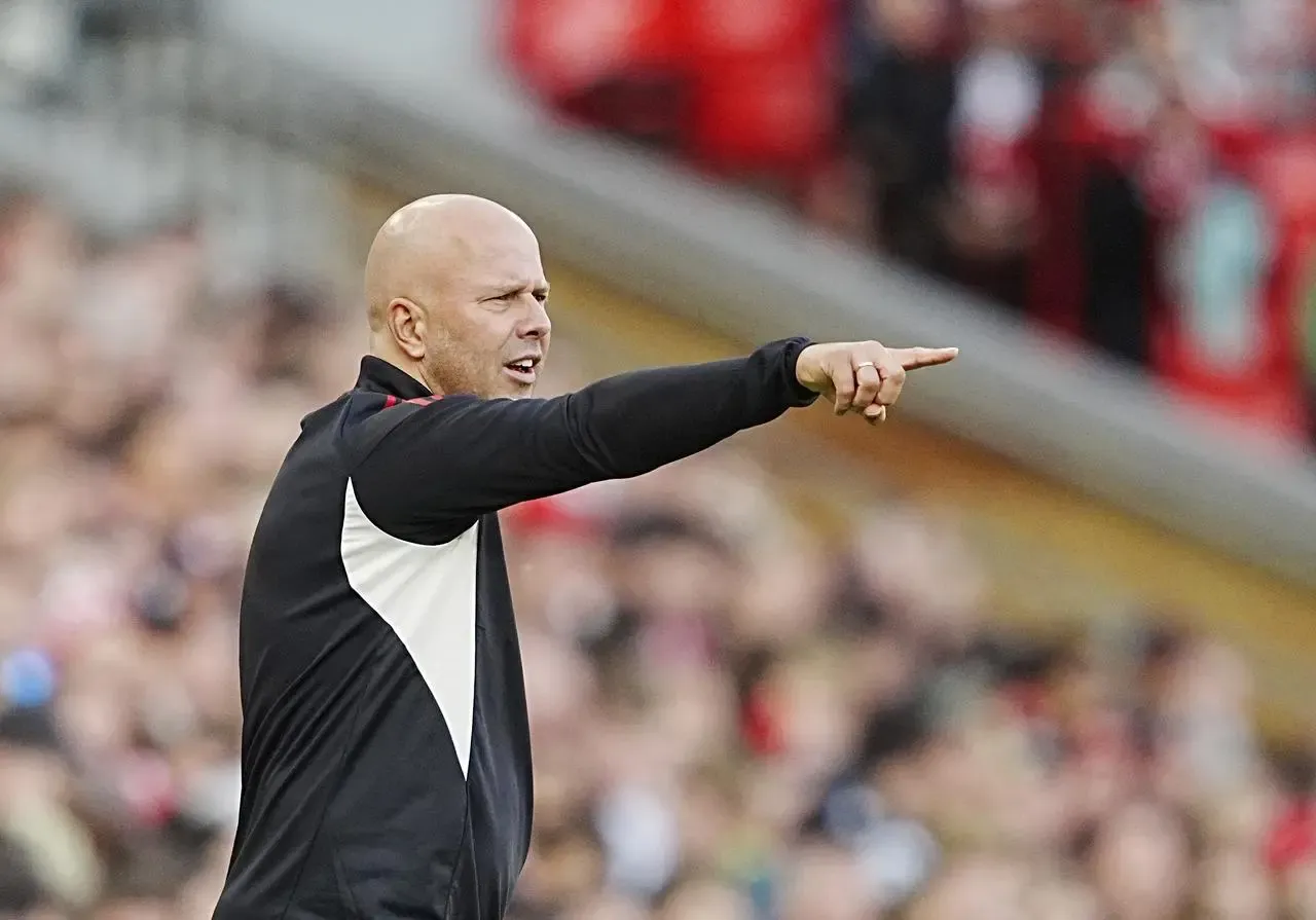 Arne Slot points from the touchline