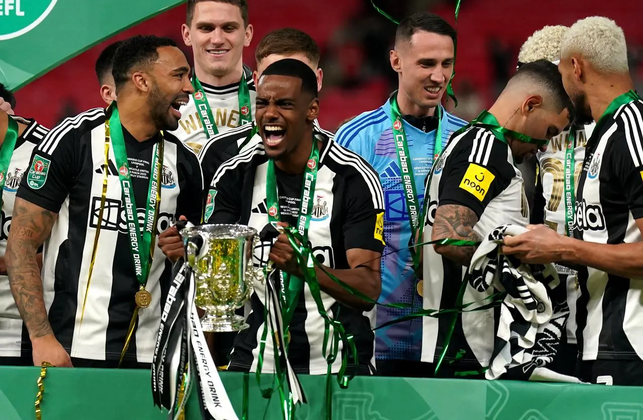 Newcastle’s Alexander Isak lifts the Carabao Cup trophy with team-mates following victory over Liverpool at Wembley