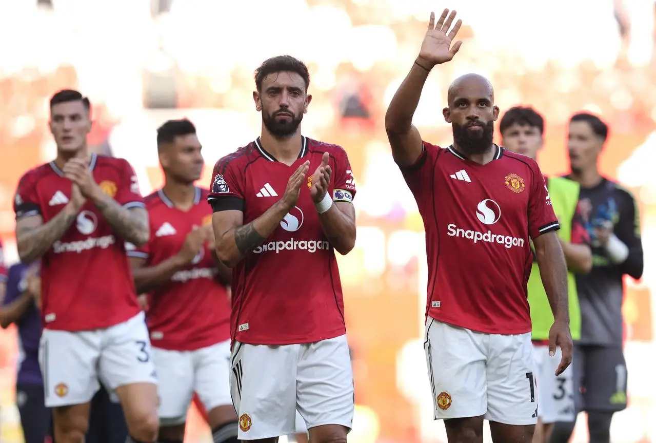 Manchester United’s Bruno Fernandes and Bryan Mbeumo (right) applaud the fans