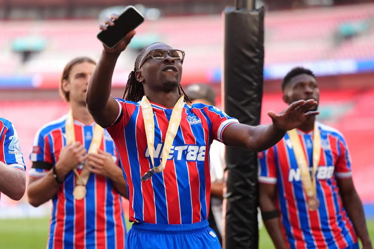 Eberechi Eze celebrates at Wembley while wearing his Community Shield medal and a pair of glasses