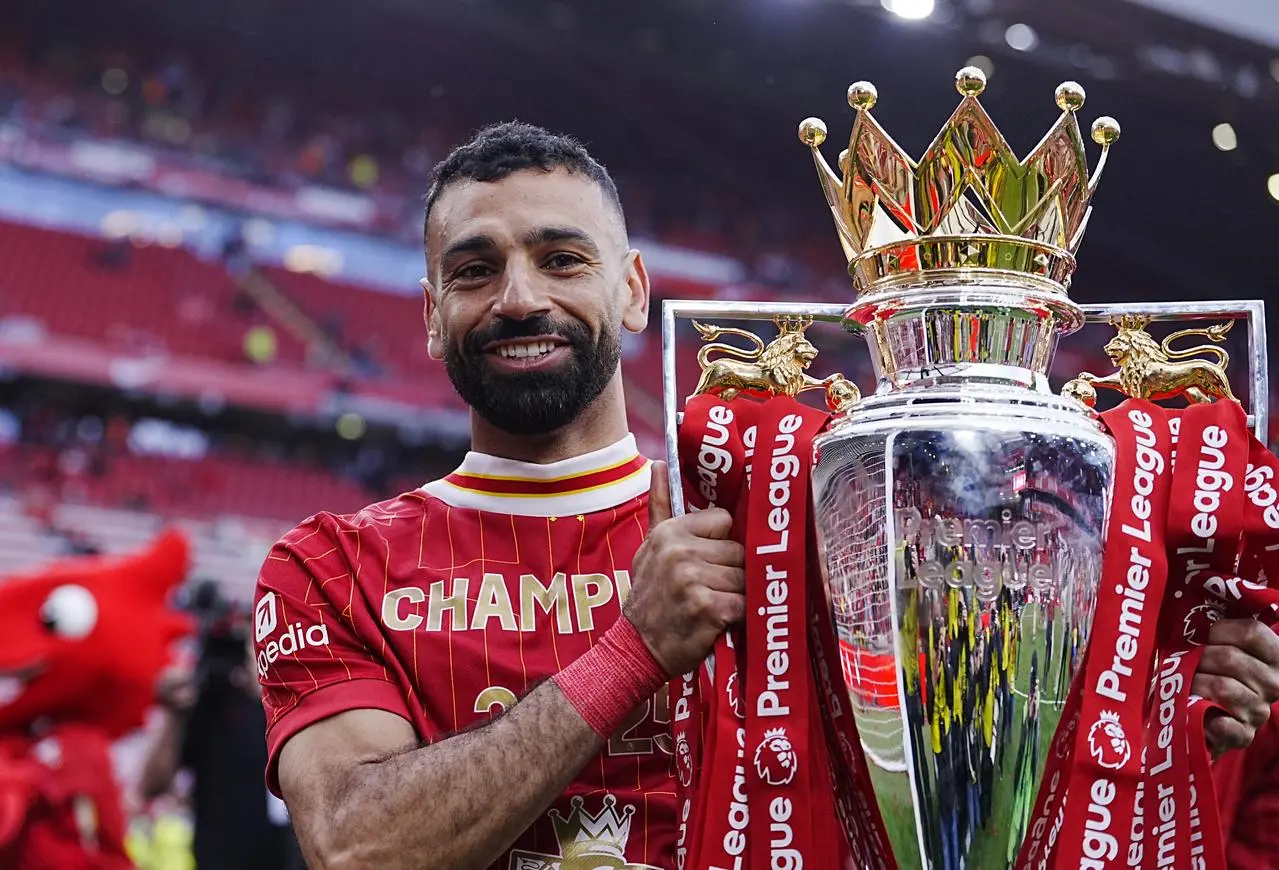 Liverpool’s Mohamed Salah celebrates with the Premier League trophy 