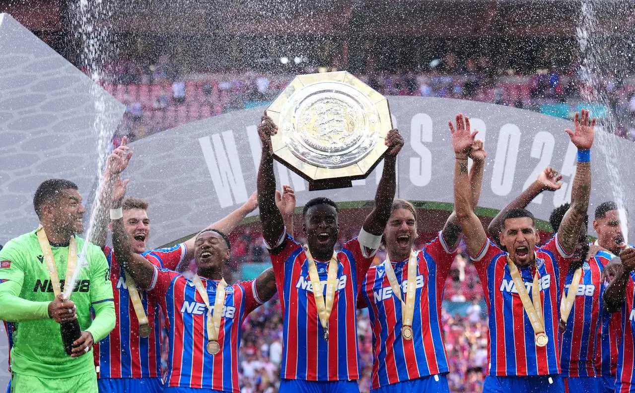 Crystal Palace’s Marc Guehi lifts the FA Community Shield in front of his team-mates
