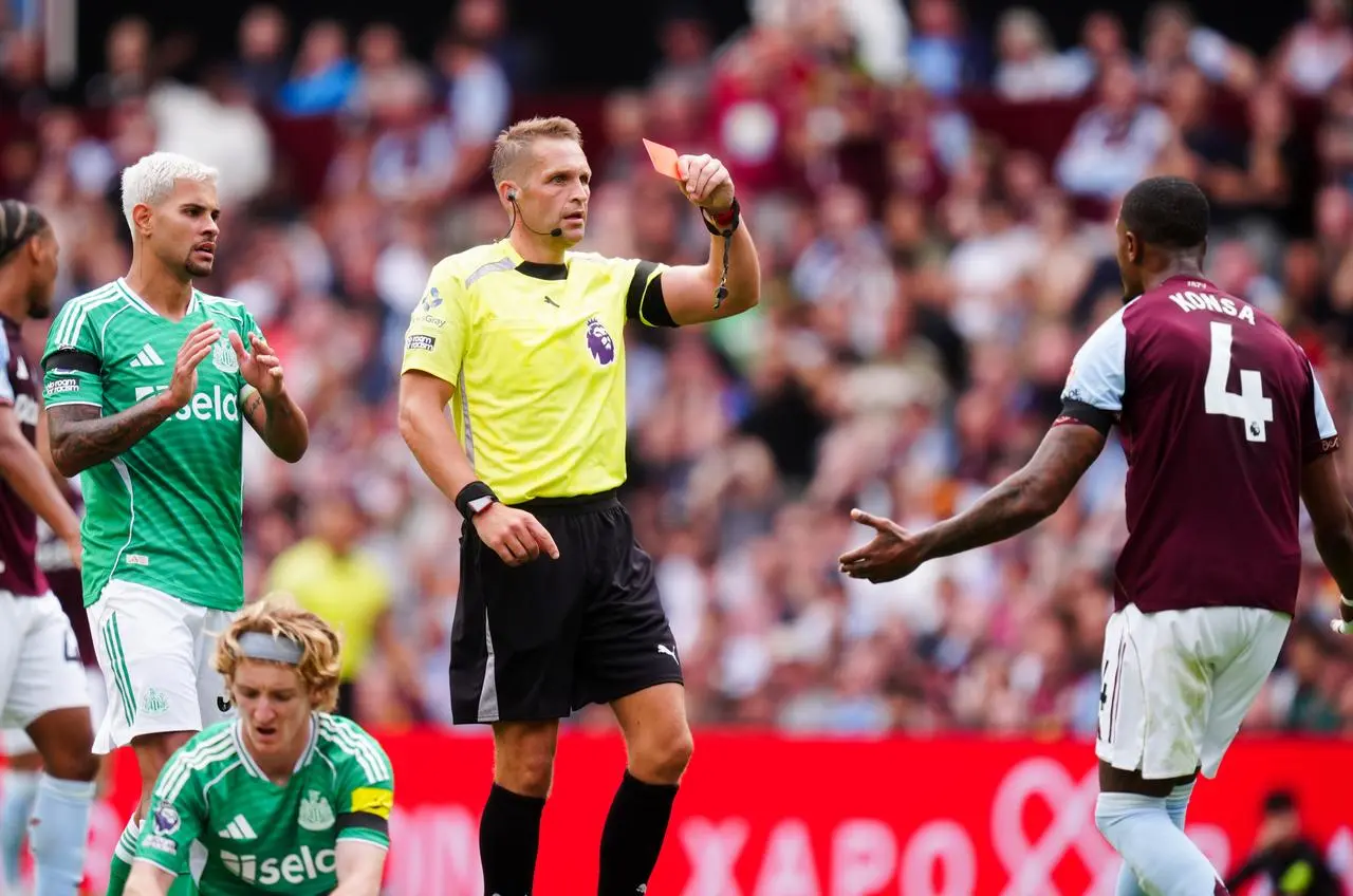 Ezri Konsa is shown a red card