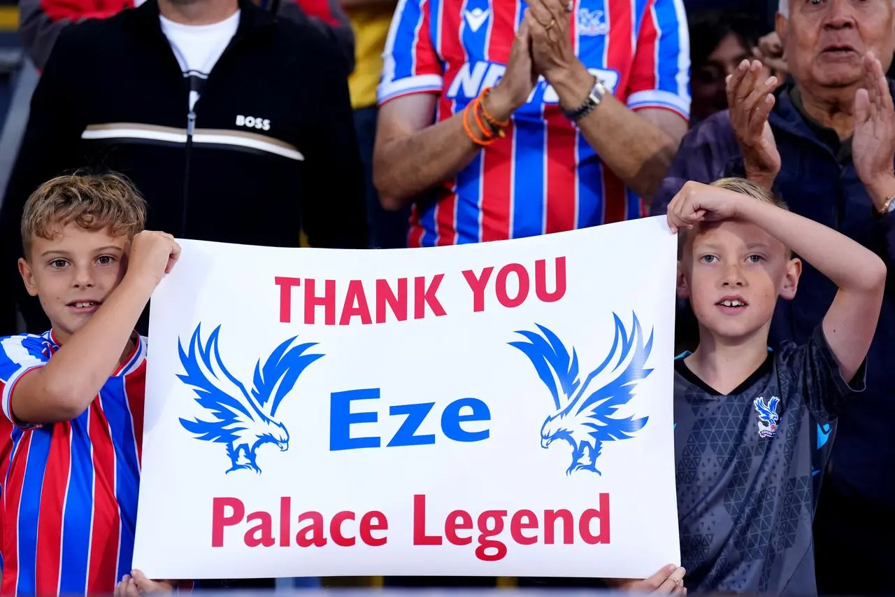 Crystal Palace fans hold up a sign