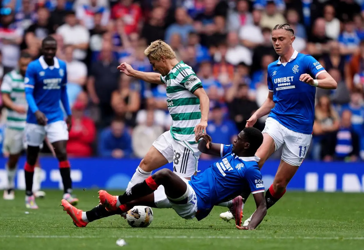 Rangers’ Nasser Djiga (centre) tackles Celtic’s Daizen Maeda (left)
