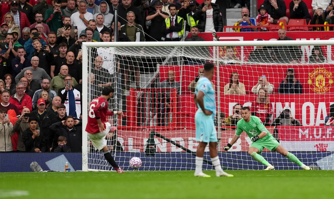Burnley goalkeeper Martin Dubravka dives in vain as Manchester United’s Bruno Fernandes scores his penalty