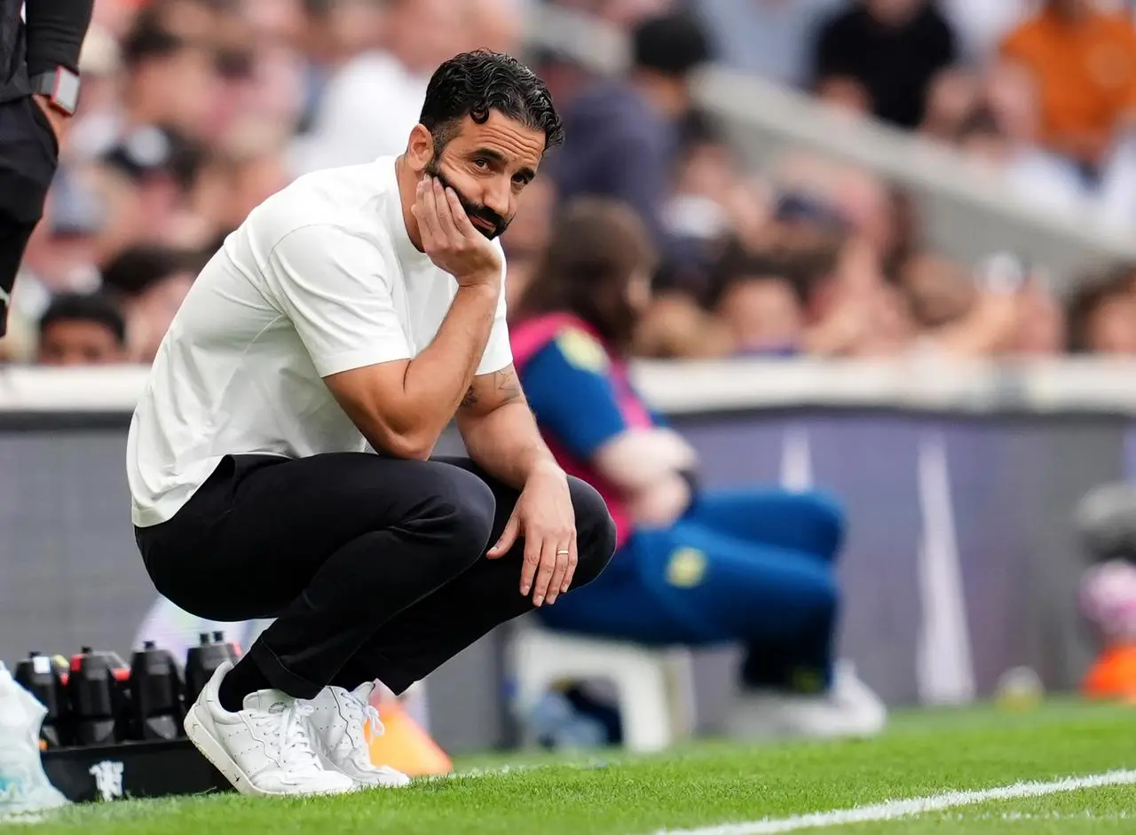 Ruben Amorim crouches down on the touchline